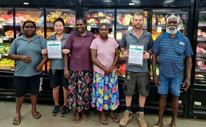 Vaccinated Outback Stores workers in Ngukurr community, with Bobby Nunggumajbarr (far right).